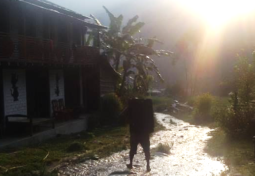 Accessing the training centre at Rangkhani-Baglung meant crossing several minor rivers as there was no transportation facility. Pictured here was a man transporting a suitcase of 40 Surface tablets to the training venue 