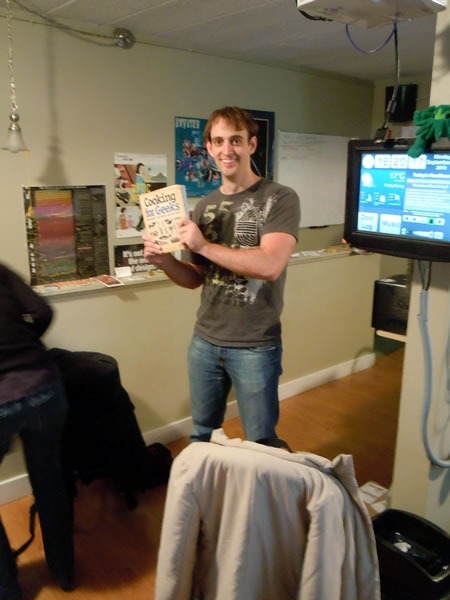 Jeff Potter poses with his book, Cooking for Geeks, at HacklabTO