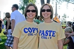 Two women, one wearing a "Copy / ctrl + V" T-shirt, the other wearing a "Paste / ctrl + V" t-shirt
