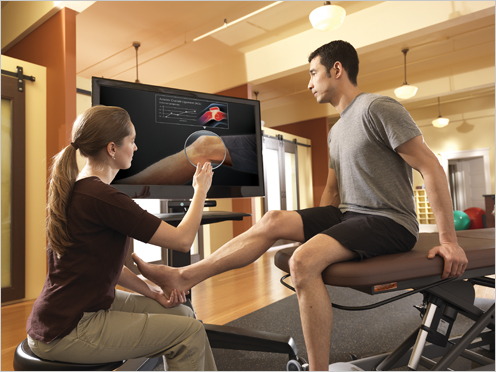 In this physical therapy scenario, Kinect for Windows enables a therapist to interact with the computer without leaving her patient’s side.