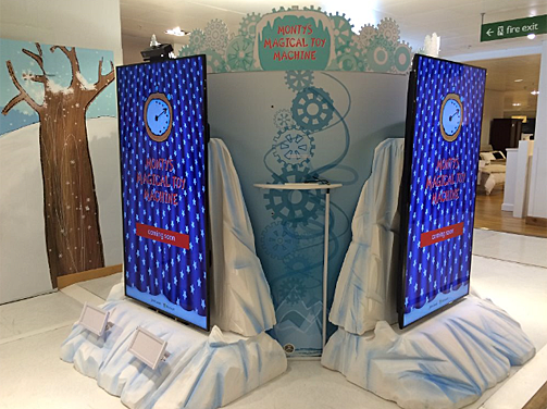The enchantment happens here, at Monty's Magical Toy Machine. Two of the enormous display screens can be seen in this photo; the screen on the left has a Kinect for Windows v2 sensor mounted above and speakers positioned below.