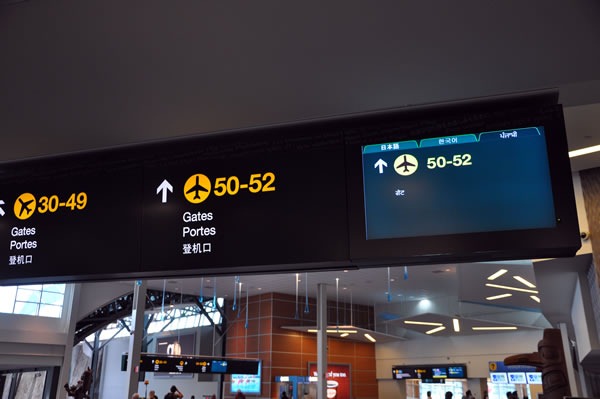 Gate signs at Vancouver airport, featuring a multilingual LCD sign using a tab control