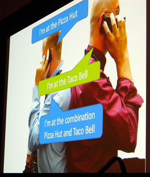 Slide showing John Oxley and Damir Bersinic on cell phones, doing the "Combination Pizza Hut and Taco Bell" song