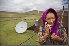 Droga 37--- Herds and milks her 120 Yaks with her daughter. Her Husband takes care of their sheep. Her sons are in school. In the last 5 years many of the nomads in the area around Lake Namtso have acquired cell phones. The satellite dish receives radio only.