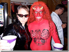 Sara Ford as Trinity, and Beth Massi as a red Devil