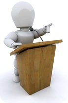 Clipart Illustration of a White Character Pointing While Standing Behind A Podium And Giving A Speech